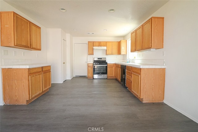 kitchen with gas range, dark hardwood / wood-style flooring, and black dishwasher