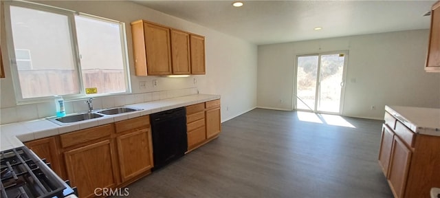 kitchen with black dishwasher, dark hardwood / wood-style floors, sink, stove, and tile countertops