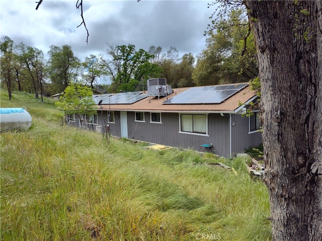 rear view of property with solar panels