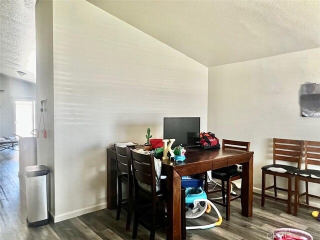 office with a textured ceiling, dark hardwood / wood-style floors, and vaulted ceiling