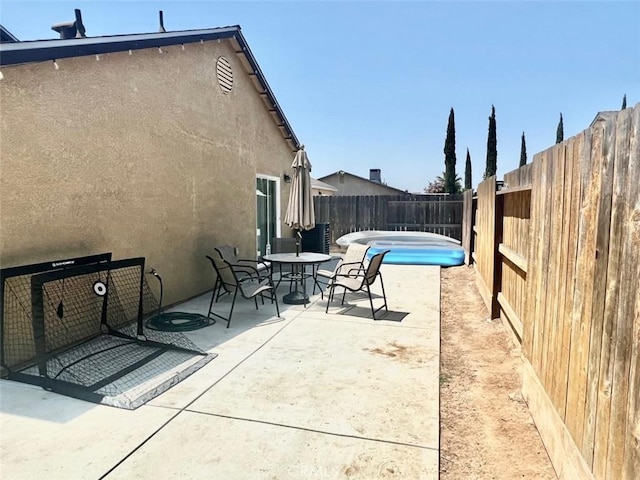 view of patio / terrace featuring a swimming pool