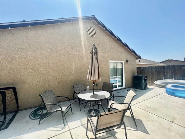 view of patio featuring central AC unit and a hot tub