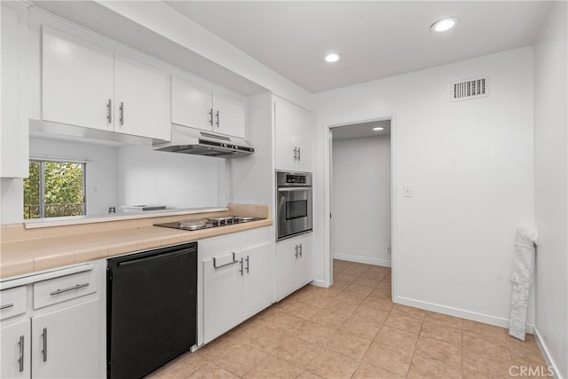 kitchen with black appliances, white cabinets, and tile counters