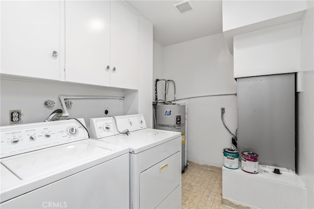 laundry area featuring washer and clothes dryer, cabinets, and electric water heater