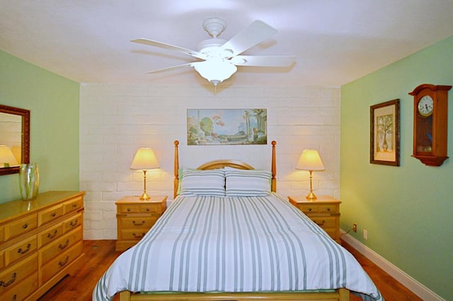 bedroom featuring ceiling fan and dark hardwood / wood-style floors