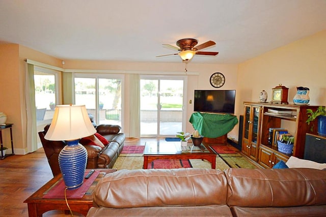 living room featuring ceiling fan and wood-type flooring