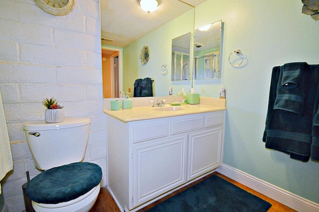 bathroom featuring hardwood / wood-style floors, vanity, and toilet