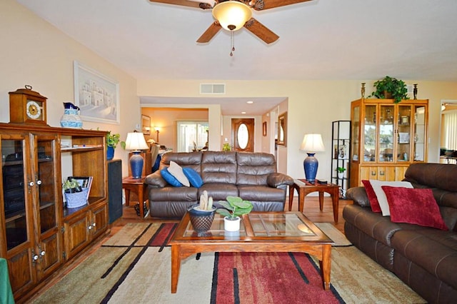 living room featuring ceiling fan and light hardwood / wood-style floors