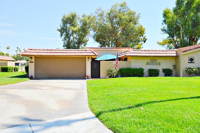 ranch-style house featuring a garage and a front lawn