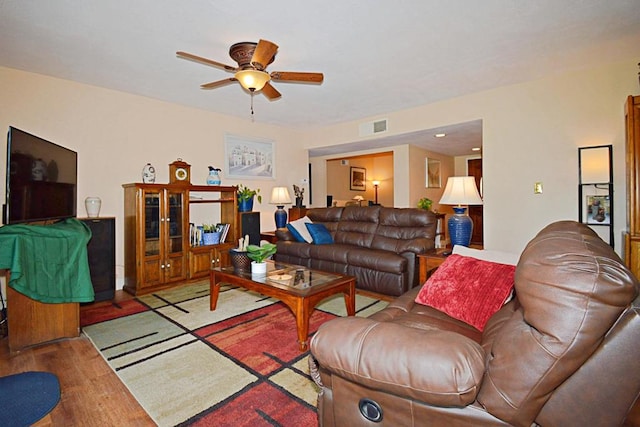 living room with ceiling fan and hardwood / wood-style flooring