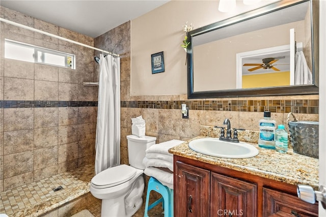 bathroom featuring ceiling fan, walk in shower, vanity, and toilet