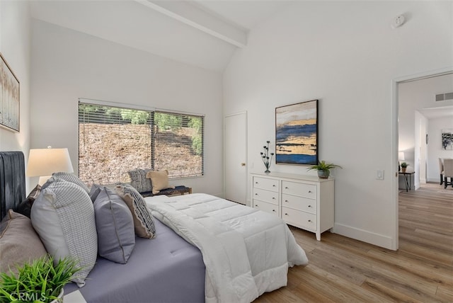 bedroom featuring light wood-type flooring, beamed ceiling, and high vaulted ceiling