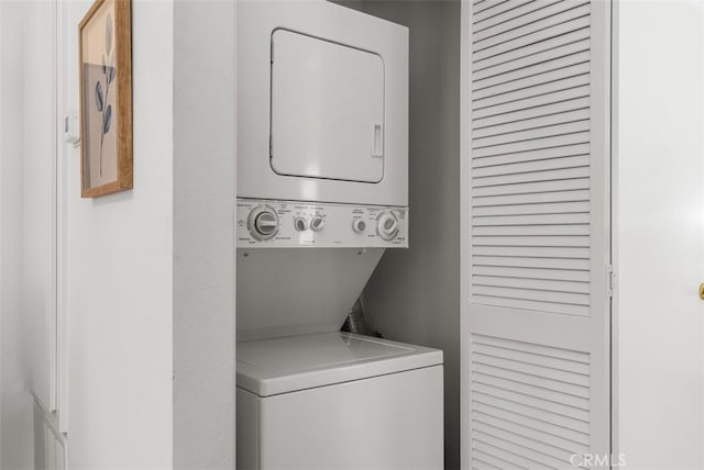 laundry room with stacked washer / dryer