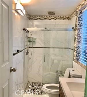 bathroom with tile walls, vanity, toilet, and an enclosed shower