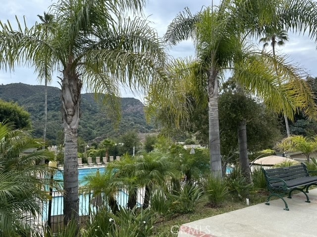 view of property's community with a mountain view and a swimming pool