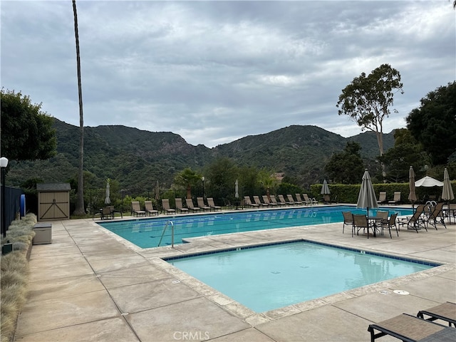 view of pool with a mountain view and a patio area