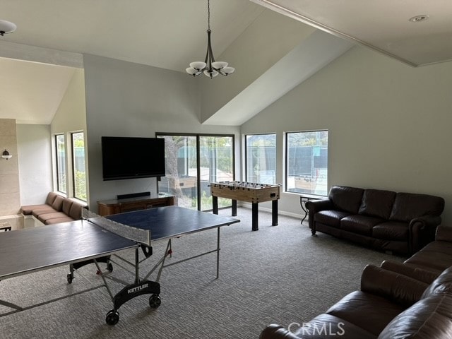 living room featuring carpet floors, a chandelier, and high vaulted ceiling