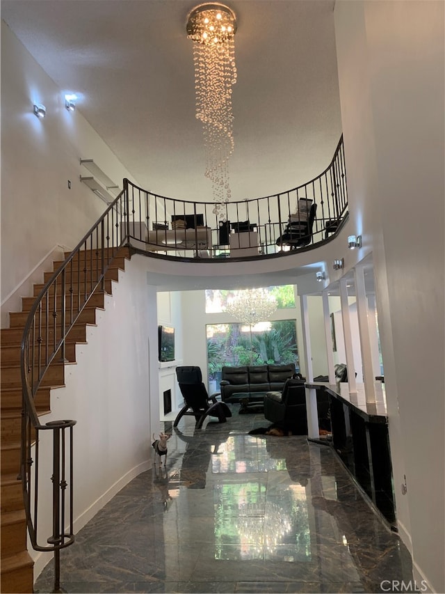 unfurnished living room with an inviting chandelier