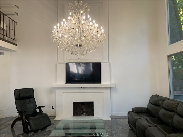 living room featuring a towering ceiling and plenty of natural light