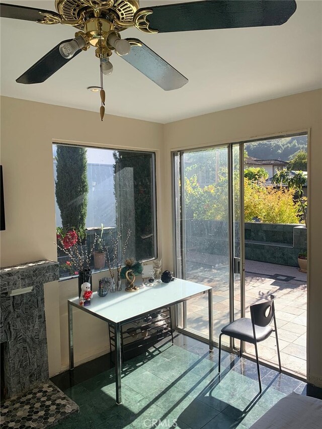 interior space with ceiling fan