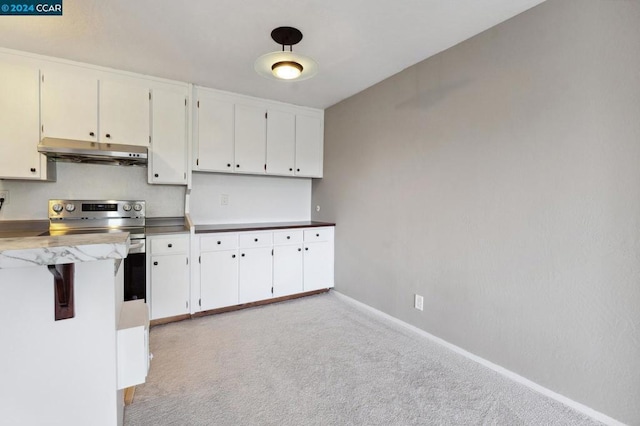 kitchen featuring light carpet, white cabinets, and stainless steel electric range