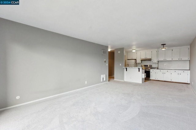 unfurnished living room featuring light carpet