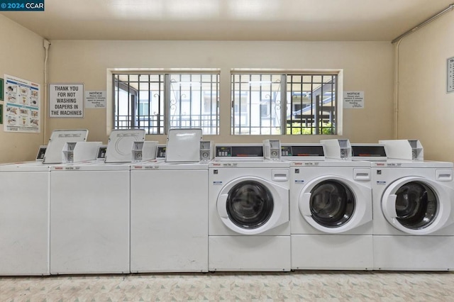 washroom featuring a wealth of natural light and washer and dryer