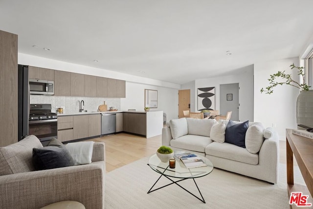 living room featuring light hardwood / wood-style floors and sink