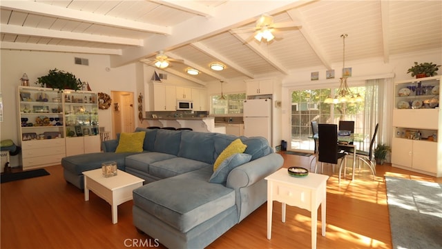 living room featuring light hardwood / wood-style floors, vaulted ceiling with beams, and ceiling fan with notable chandelier