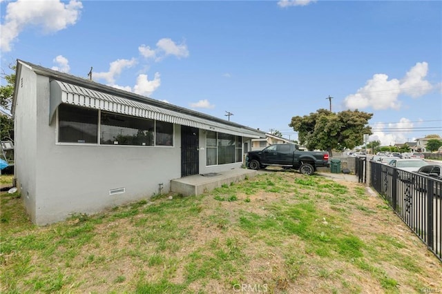 rear view of property featuring a yard