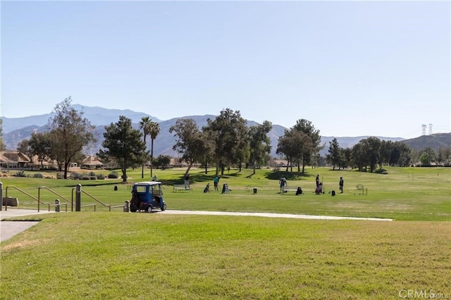 view of property's community with a mountain view and a yard