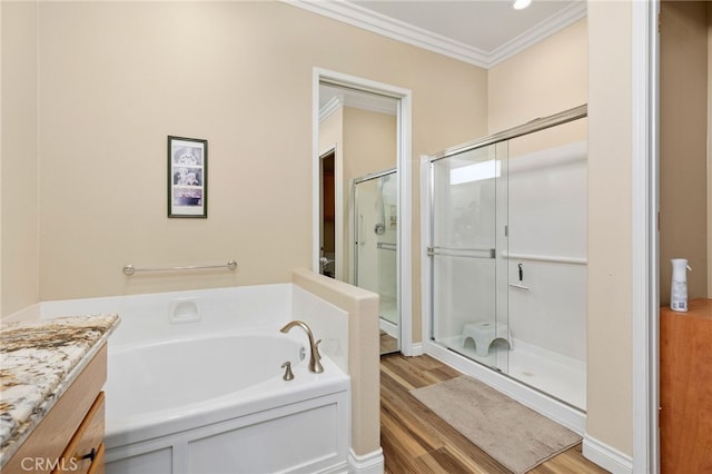 bathroom featuring crown molding, shower with separate bathtub, vanity, and hardwood / wood-style floors