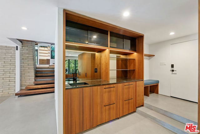 kitchen with dark stone countertops and sink