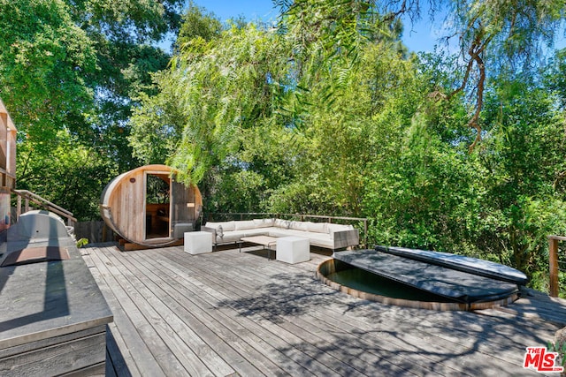 wooden terrace with an outdoor living space