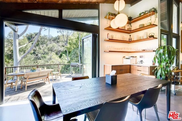 dining room with lofted ceiling with beams and wooden ceiling