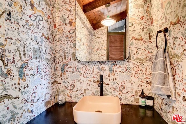 bathroom featuring wood ceiling, sink, and vaulted ceiling