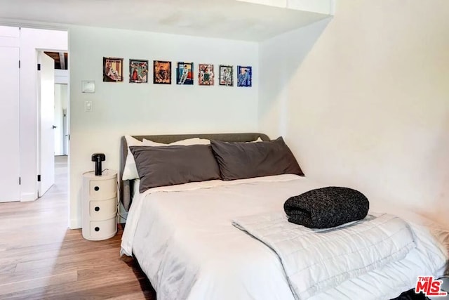 bedroom with wood-type flooring