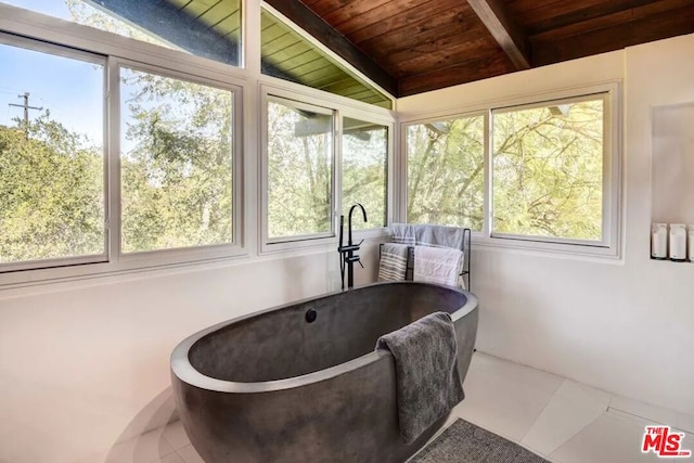 sunroom with lofted ceiling with beams, plenty of natural light, and wooden ceiling