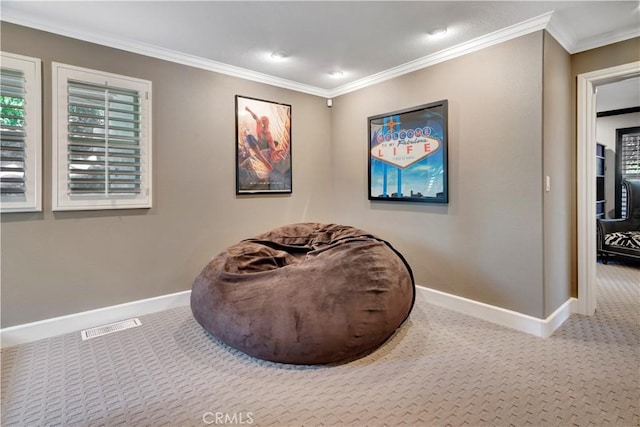 sitting room featuring carpet floors and ornamental molding