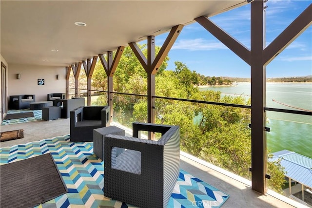 sunroom / solarium featuring plenty of natural light and a water view