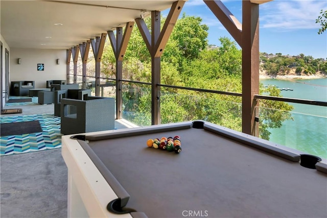 unfurnished sunroom featuring a water view and pool table