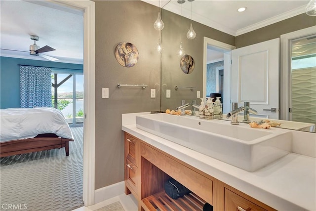 bathroom featuring ceiling fan, crown molding, and vanity