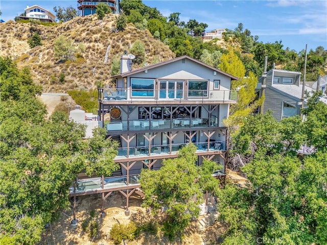 back of house with a balcony