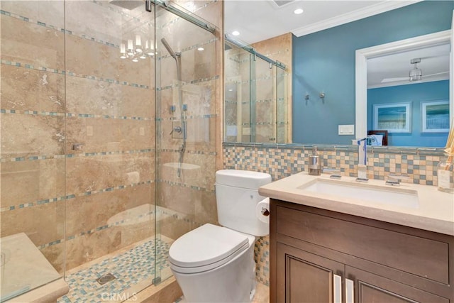 bathroom with vanity, toilet, ornamental molding, tile walls, and walk in shower