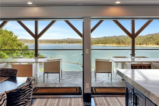 balcony featuring a water view and an outdoor bar