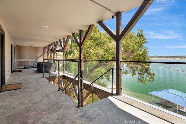 unfurnished sunroom featuring a water view