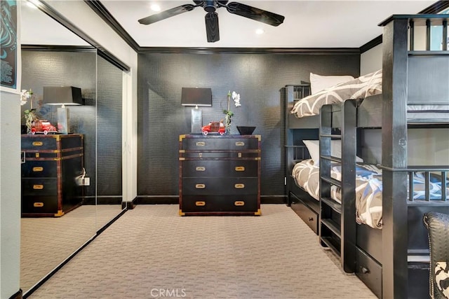 carpeted bedroom with ceiling fan and ornamental molding