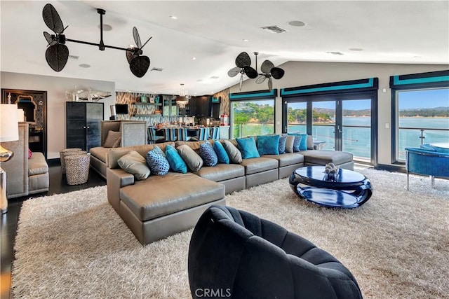 living room with ceiling fan, french doors, and vaulted ceiling