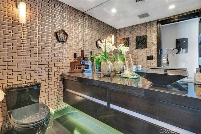 bar with tile patterned floors and sink