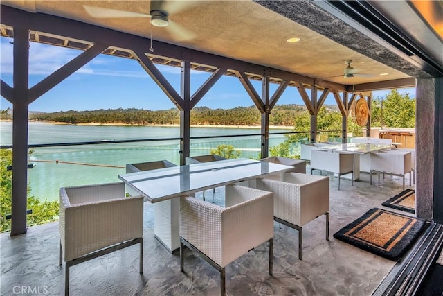 view of patio featuring ceiling fan and a water view